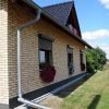 izoflex plytelės spalva 103 19 geltonas namo fasadas